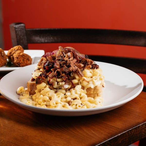 Harold Dean Smoked Goods' mac and cheese topped with pulled pork and caramelized onions.